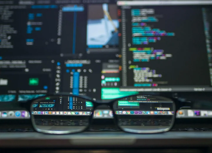 Close-up of a laptop screen with code and data analysis, representing Infrastructure as Code (IaC) for business scalability